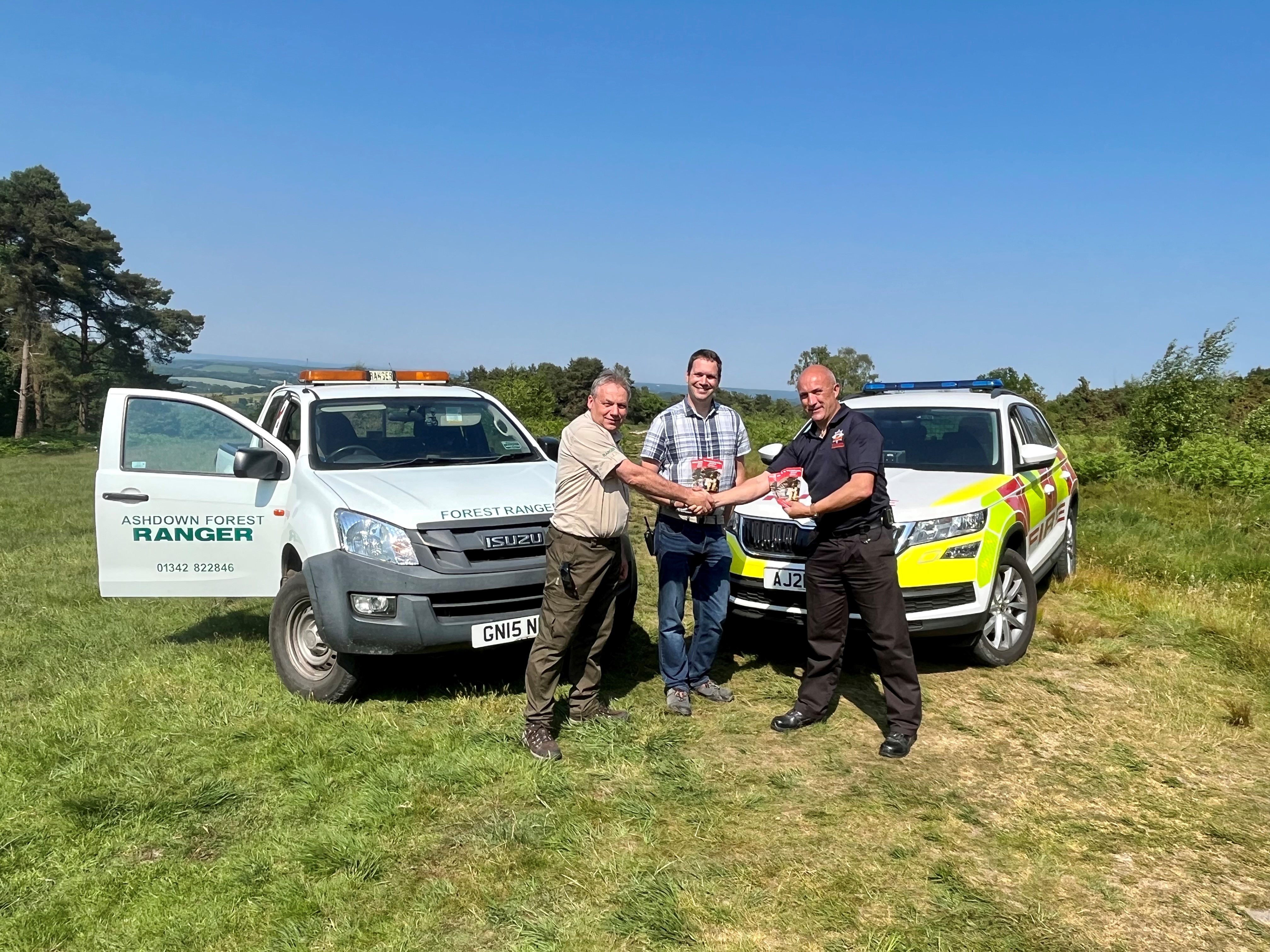Photo of East Sussex Fire and Rescue Service providing wildfire safety leaflets to Ashdown Forest Rangers