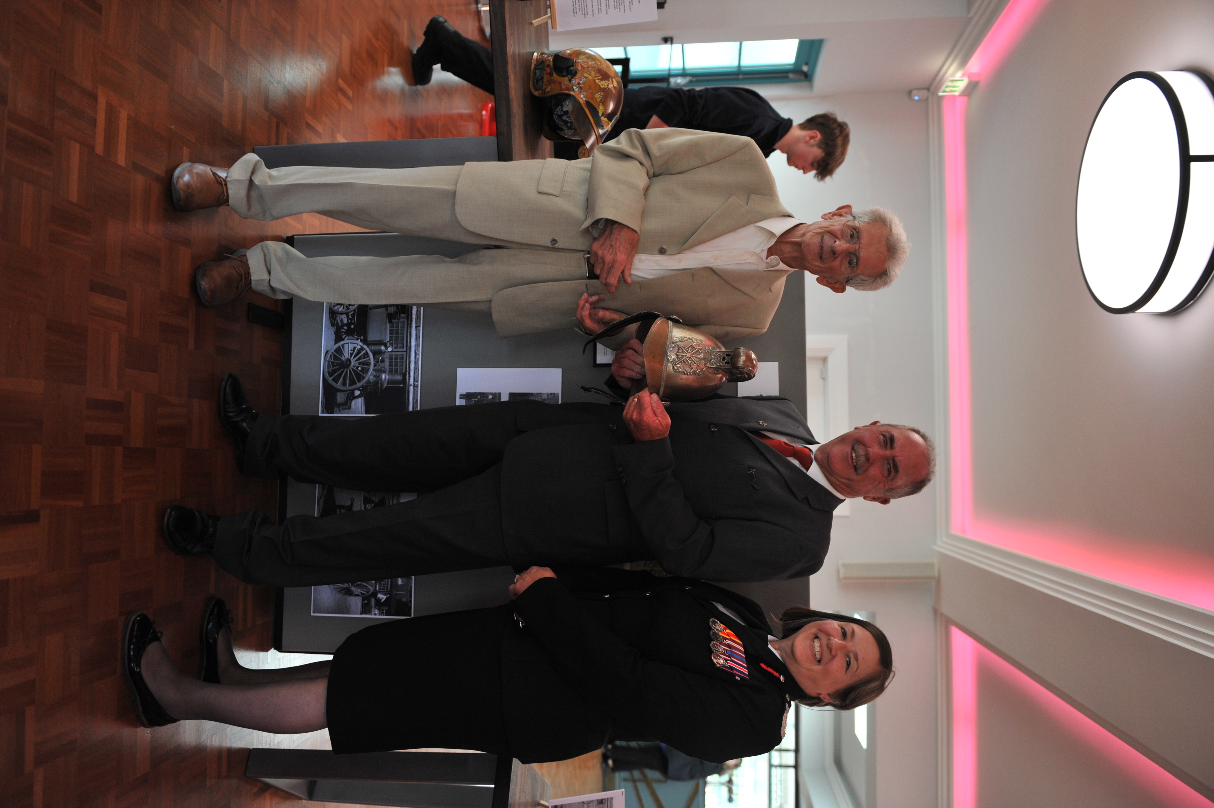 Previous CFO Eric Whitaker, previous Executive Support Officer Keith Ring and CFO Dawn Whittaker posing in front of Merryweather display. 