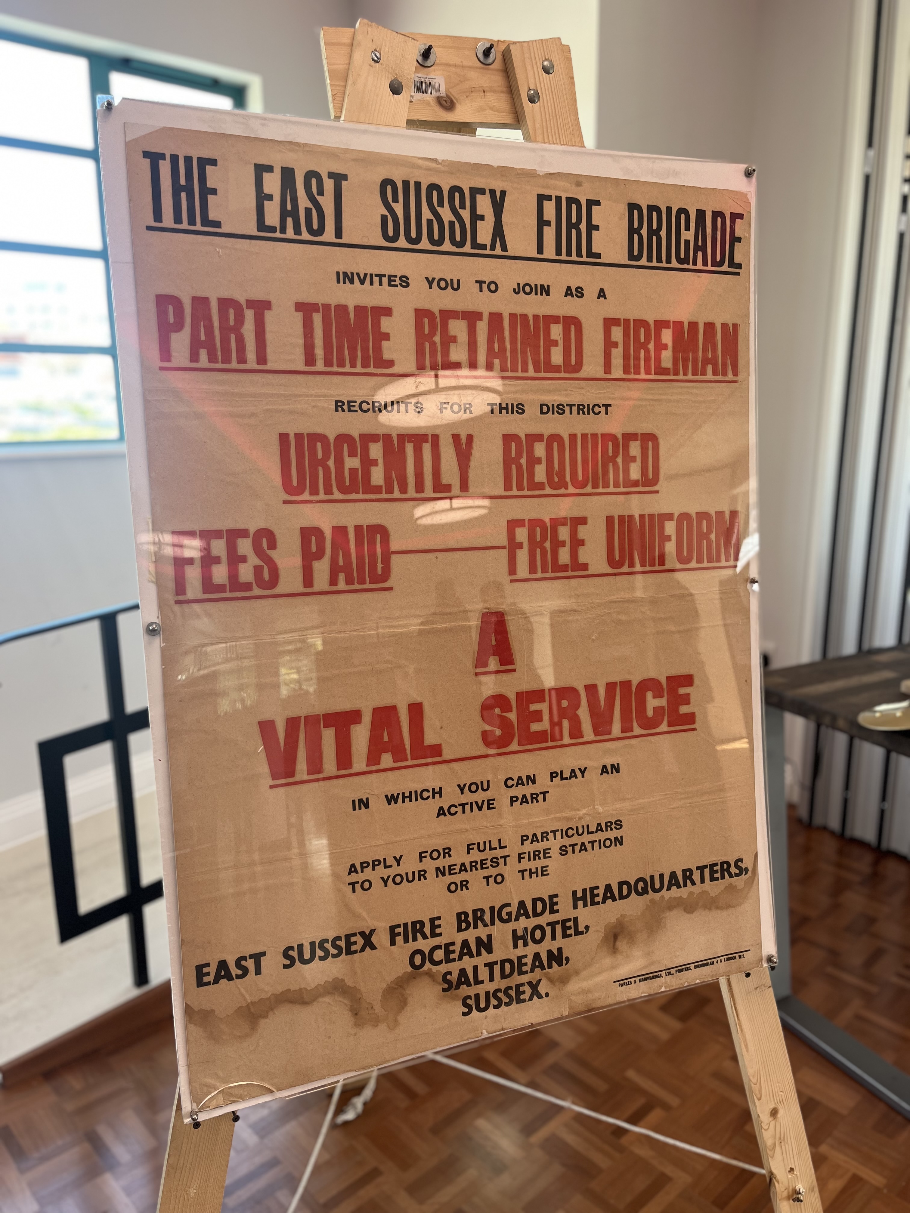 Large poster board of old East Sussex Fire and Rescue retained firefighter advert